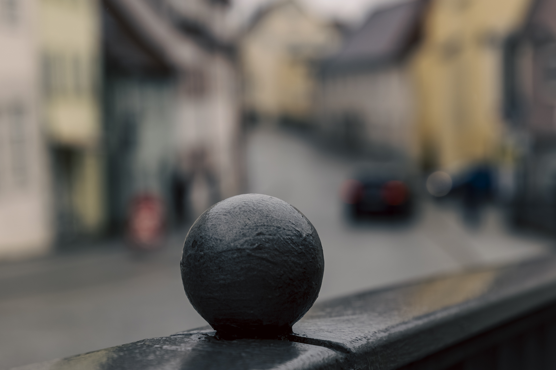 Regennasse Stahlkugel auf Geländer an der Stadtreppe zu Günzburg.